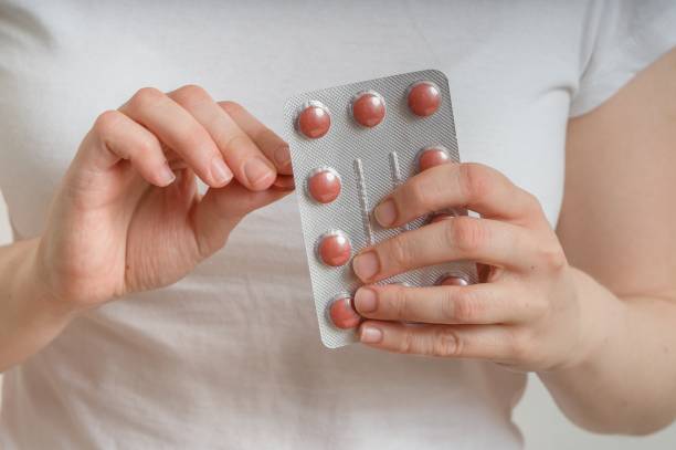 istock Young woman is taking pills from blister pack. 644093144