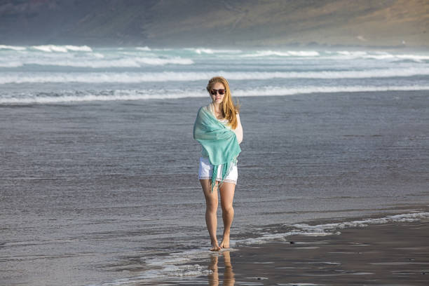 istock Woman walking on the coast 644095724