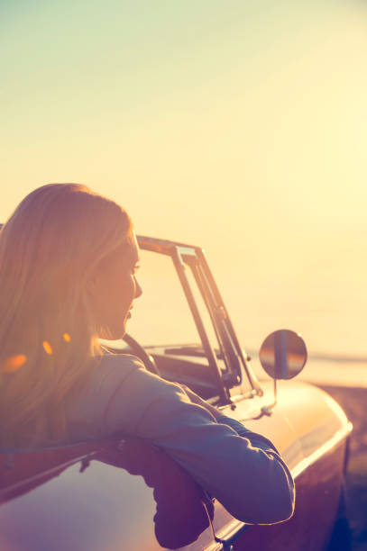 istock Young woman in a car at the beach. 644101752