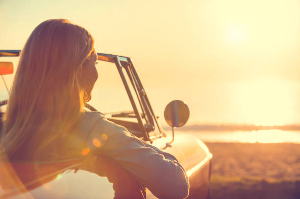 istock Young woman in a car at the beach. 644101758