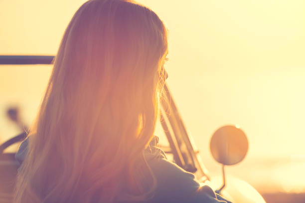 istock Young woman in a car at the beach. 644101768