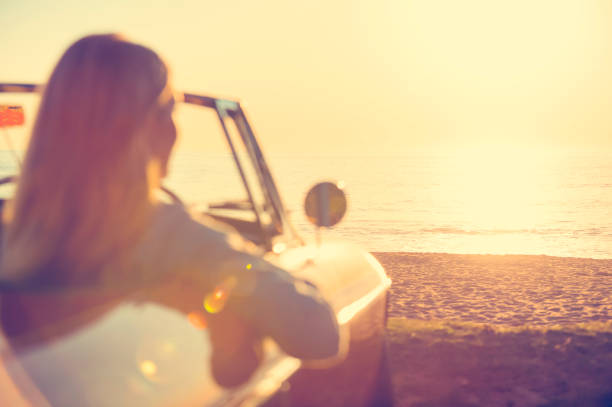 istock Young woman in a car at the beach. 644101770