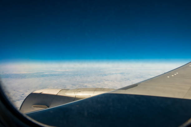 Part of wing and engine of airplane from window. Horizontal composition. Image taken with Nikon D800 and developed from RAW format.