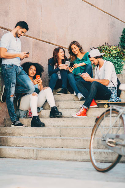 istock Friends browsing the net outdoors 644115640
