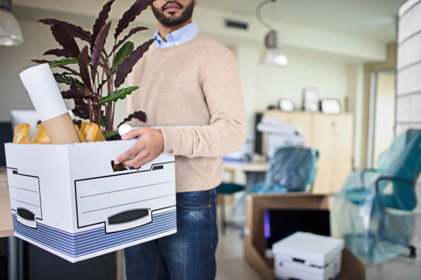 istock Businessman carrying crate in new office 644119182