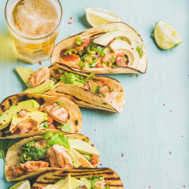 Corn chicken and avocado tortillas, beer in glass, square crop
