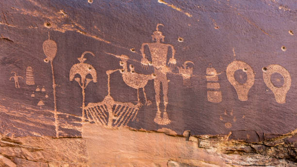 Butler Wash Wolfman Petroglyph panel A petroglyph panel with a variety of humanoid and animal images portrayed on the cliffs of Butler Wash in the Comb Ridge aea of the new Bears Ears National Monument. anasazi stock pictures, royalty-free photos & images