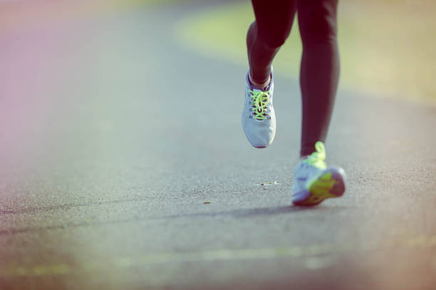 istock African American woman training and jogging by river 644132170
