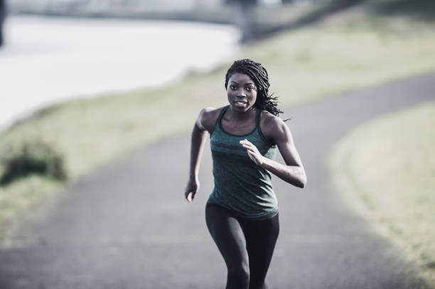 istock African American woman training and jogging by river 644132182