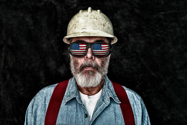 istock Patriotic construction worker with US Flag reflection in sunglasses 644135484