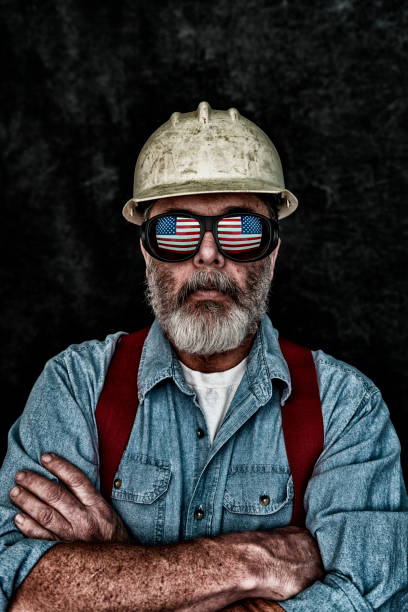 Patriotic construction worker with US Flag reflection in sunglasses