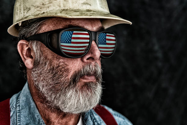 istock Patriotic construction worker with US Flag reflection in sunglasses 644135572