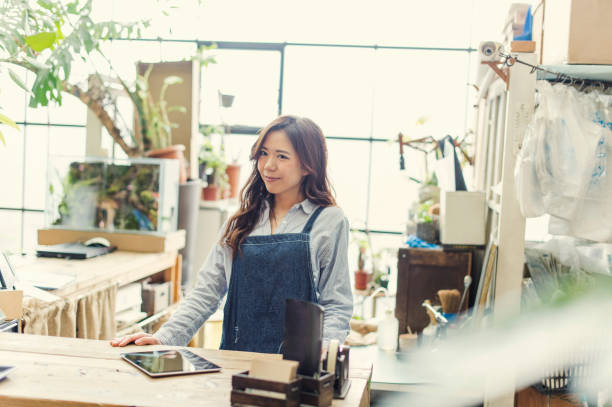 istock Young female worker working in green shop. 644135622
