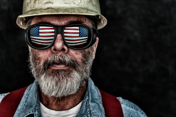 istock Patriotic construction worker with US Flag reflection in sunglasses 644135702