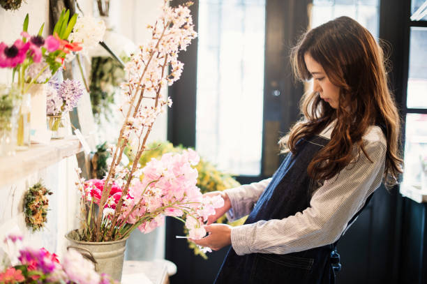 istock Young female worker working in flower shop. 644135790
