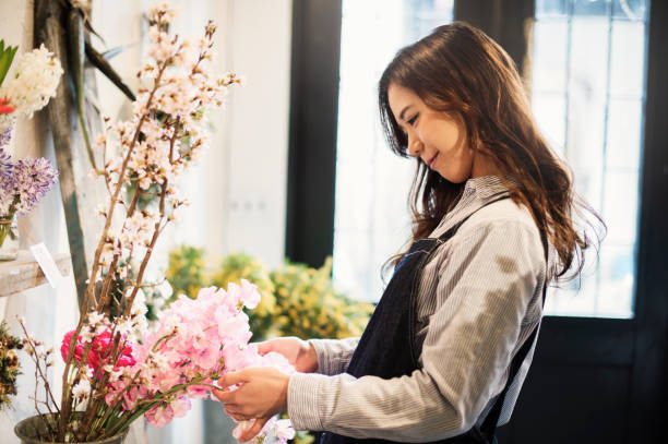 istock Young female worker working in flower shop. 644135800