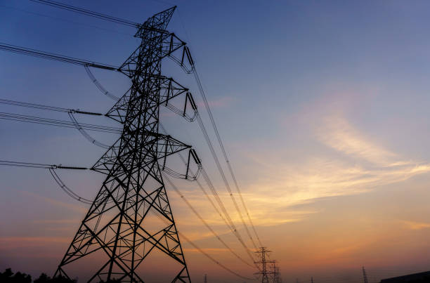 istock Silhouetted high voltage electric pylon in sun set background 644138104