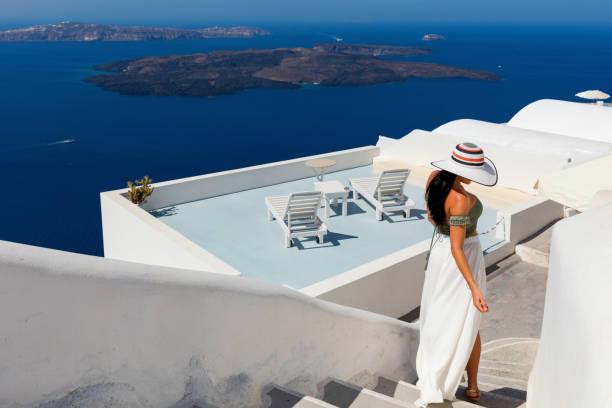 istock Attractive woman walking in sunny Santorini 644141926