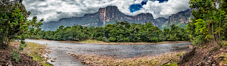 Angel falls view from Churun river camp at Auyan Tepui, Canaima National Park, Venezuela. Canaima is a world known place for the beauty of nature and countless waterfalls. Canaima is visited for tourist all around the world looking for adventure and nature encounters. Angel waterfall, with 979 meters drop is the highest waterfall in the world.