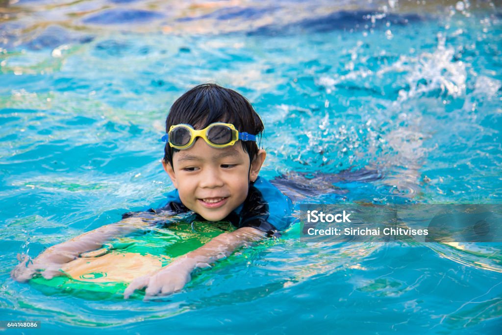 boy learn to swim in the swimming pool Swimming Stock Photo