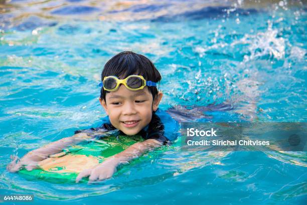 Boy Learn To Swim In The Swimming Pool Stock Photo - Download Image Now - Swimming, Child, Learning