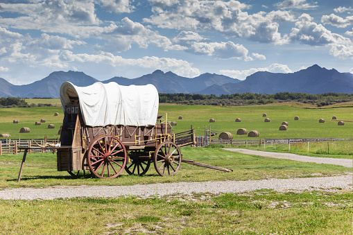 covered wagon against a mountain backdrop