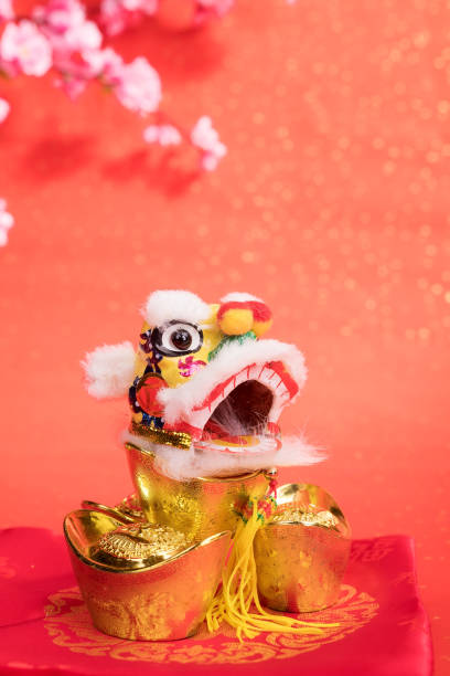 istock chinese traditional dancing lion with ingot 644162668
