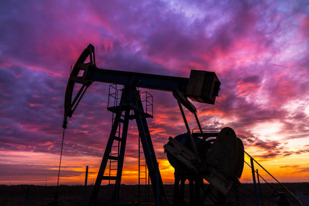 istock Scenery with oil and gas well pump and dramatic sunset 644167738