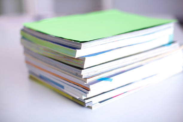 istock close up of stack of papers on white background 644175714