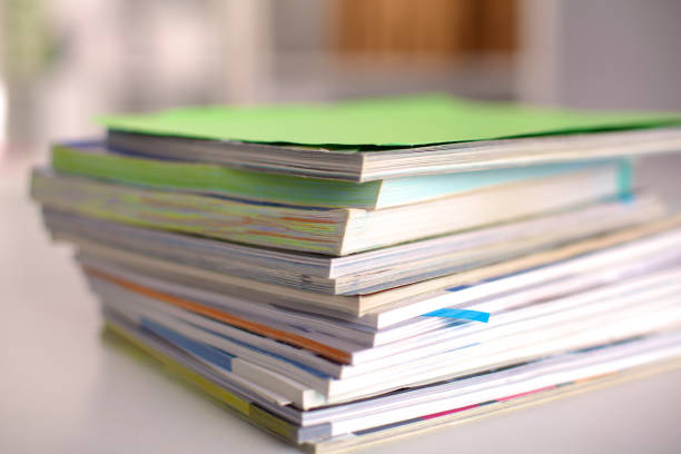 istock close up of stack of papers on white background 644175748