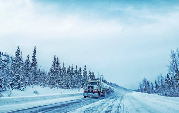 Alaska Transportation Picture of a semi-truck as it makes its way up the Richardson Highway, in Alaska.  The stunning landscape of the Alaskan winter makes for an amazing display of nature’s beauty.  Picture was taken near Valdez, Alaska, in the winter. prince william sound photos stock pictures, royalty-free photos & images
