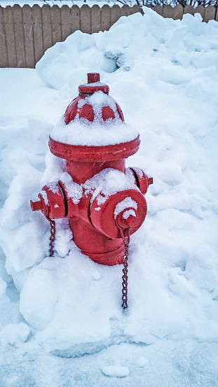 Picture of a red fire hydrant covered in snow.  Picture was taken on a cold, snowy, day in Valdez, Alaska.