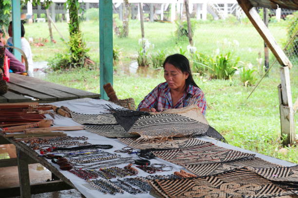 Mulu, Sarawak, Malaysia - November 18, 2016: Sarawak local Penan woman works on native traditional handicrafts