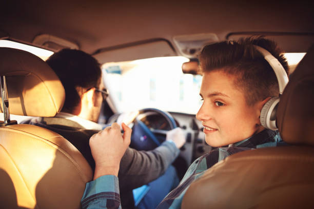 istock father and son driving in car 644182134