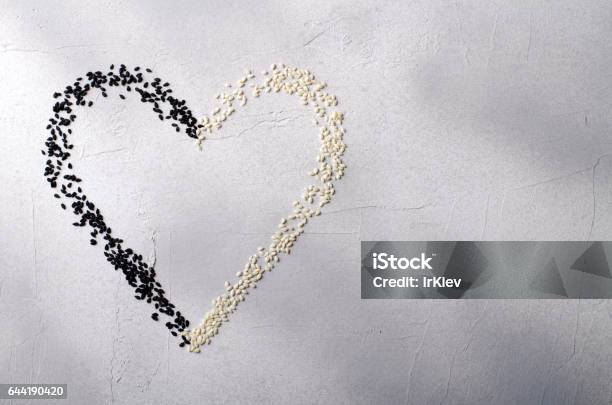 Heart Made With Black And White Sesame Seeds On Gray Background Love Valentines Day Concept Top View Copy Space Stock Photo - Download Image Now