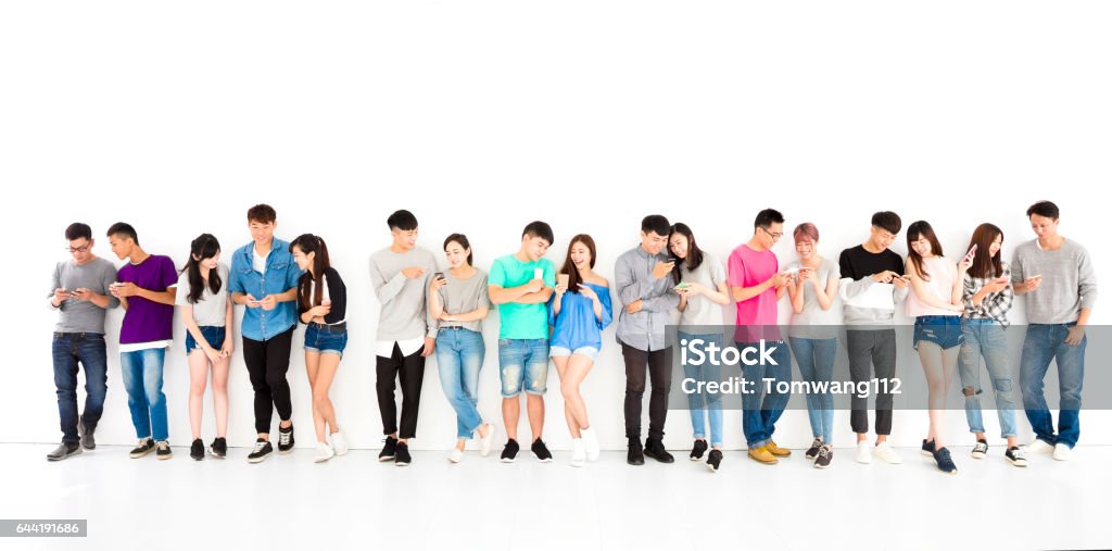 happy young student Group watching smart phone Group Of People Stock Photo