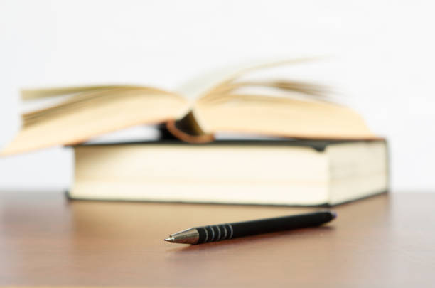 a stack of colorful books in a library or a room, soft