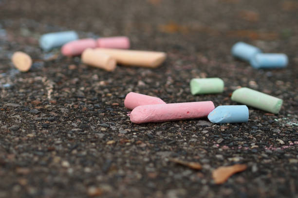istock Colorful pieces of chalk on the sidewalk 644199208