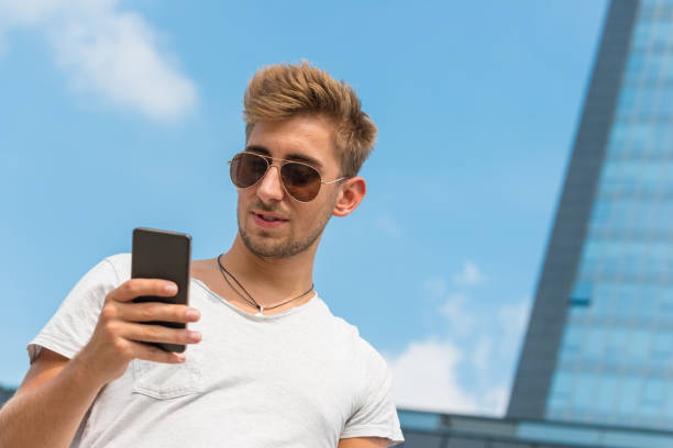 istock Young casual man using a smart phone in the street 644213570
