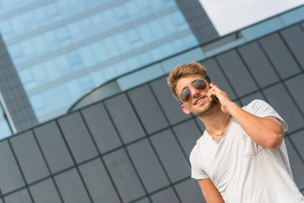 istock Young casual man using a smart phone in the street 644213578