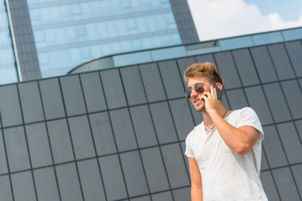 istock Young casual man using a smart phone in the street 644213588