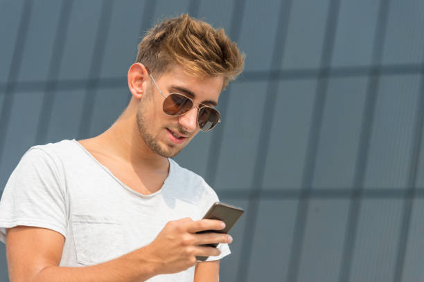 istock Young casual man using a smart phone in the street 644213592