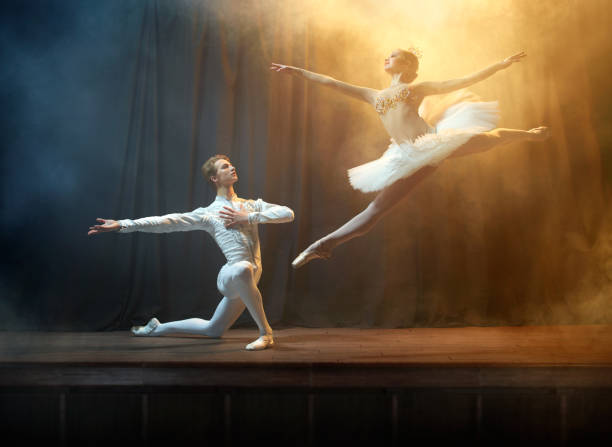 istock Ballet dancers performing on stage in theatre 644217130