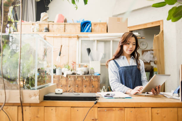 istock Young female worker working in flower shop. 644218080