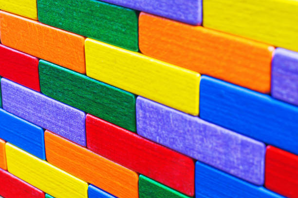 Multicolored wood background. Background with colorful shapes wooden blocks. Colorful wall, toy colored wooden bricks. Multicolor wooden blocks.