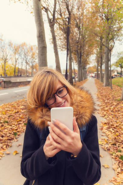 istock Cute girl posing for selfie on a sidewalk in Paris. 644225438