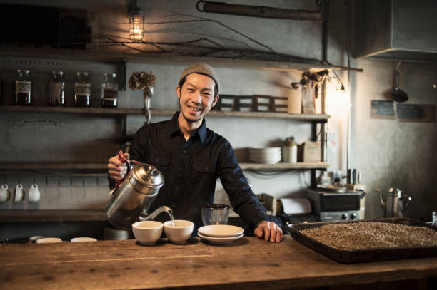 Male cafe owner preparing coffee in coffee shop