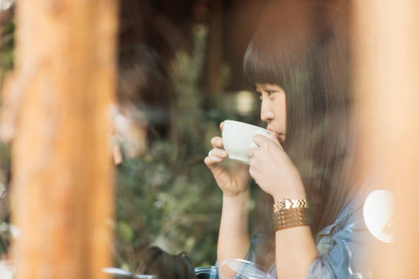 Young woman drinking coffee in a coffee shop.