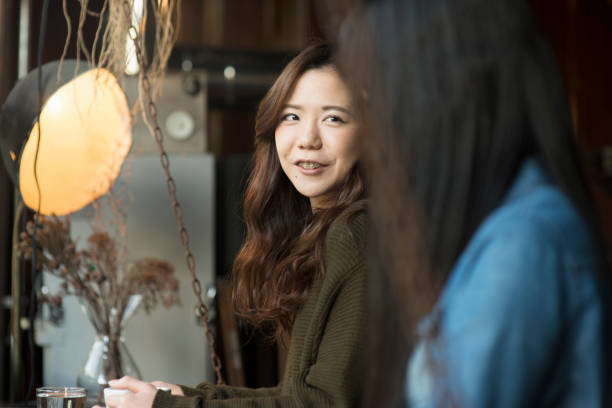 istock Two young women relaxing in a coffee shop. 644228562