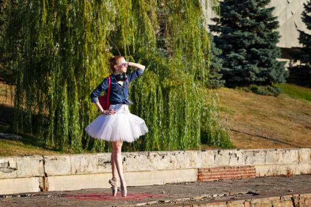 istock Hipster Ballerina dancing in autumn park. 644228796